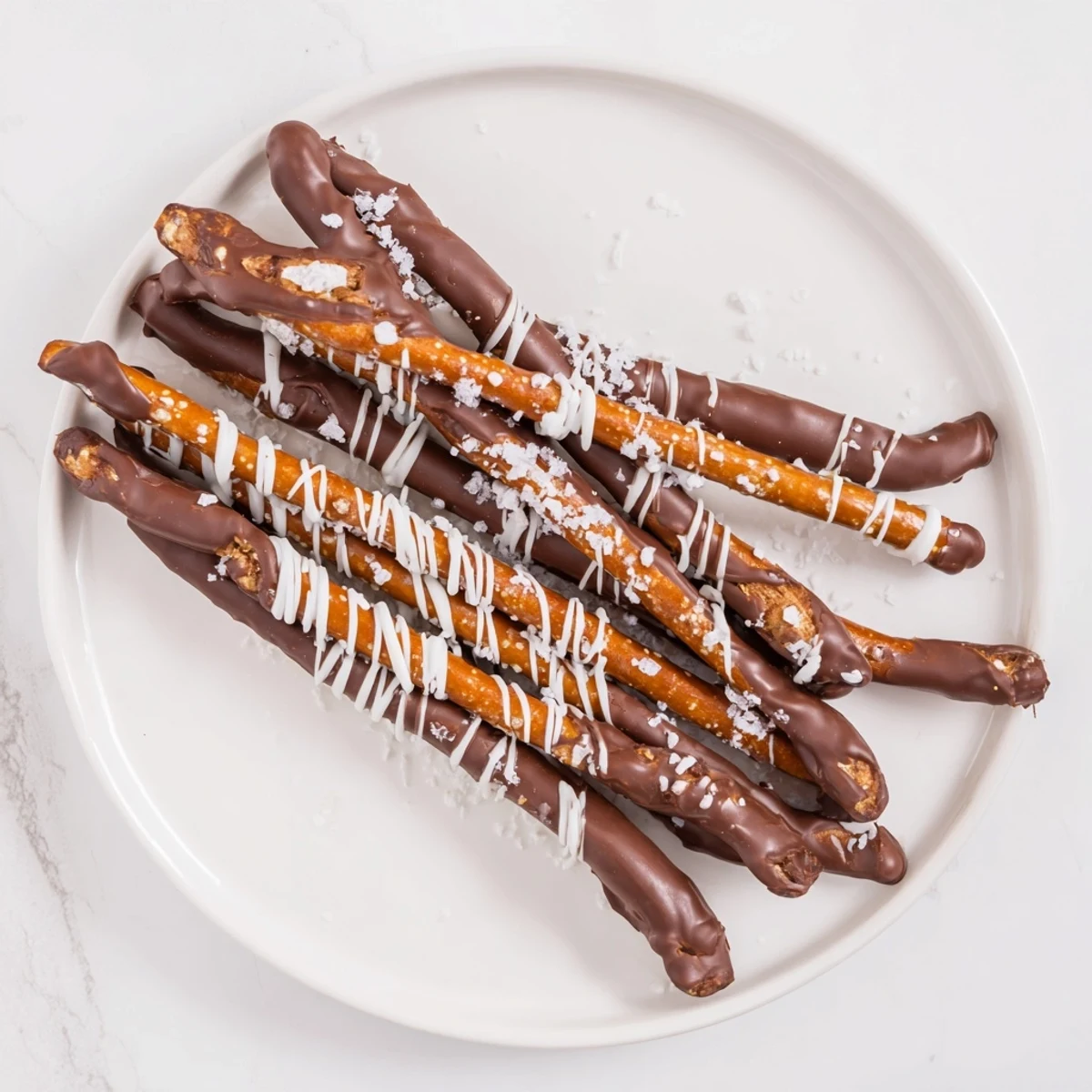 Golden, crisp pretzel rods beautifully coated in chocolate, topped with sea salt for the chocolate-dipped pretzels.