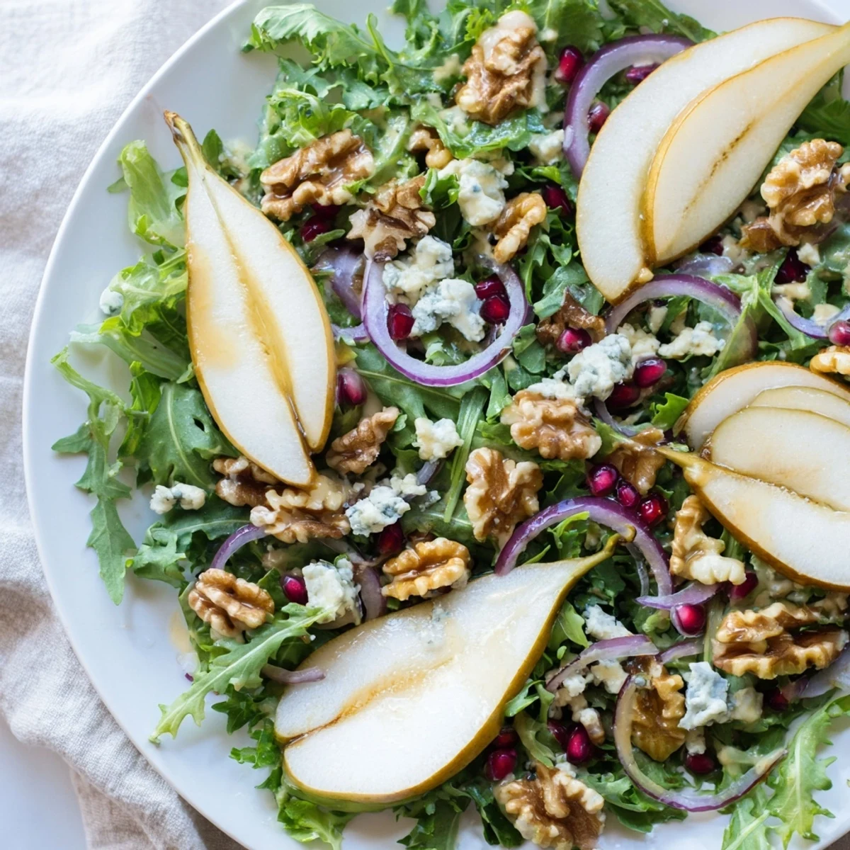 Aromatic, toasted walnuts and juicy pears atop a fresh Winter Green Salad, perfect for a side.