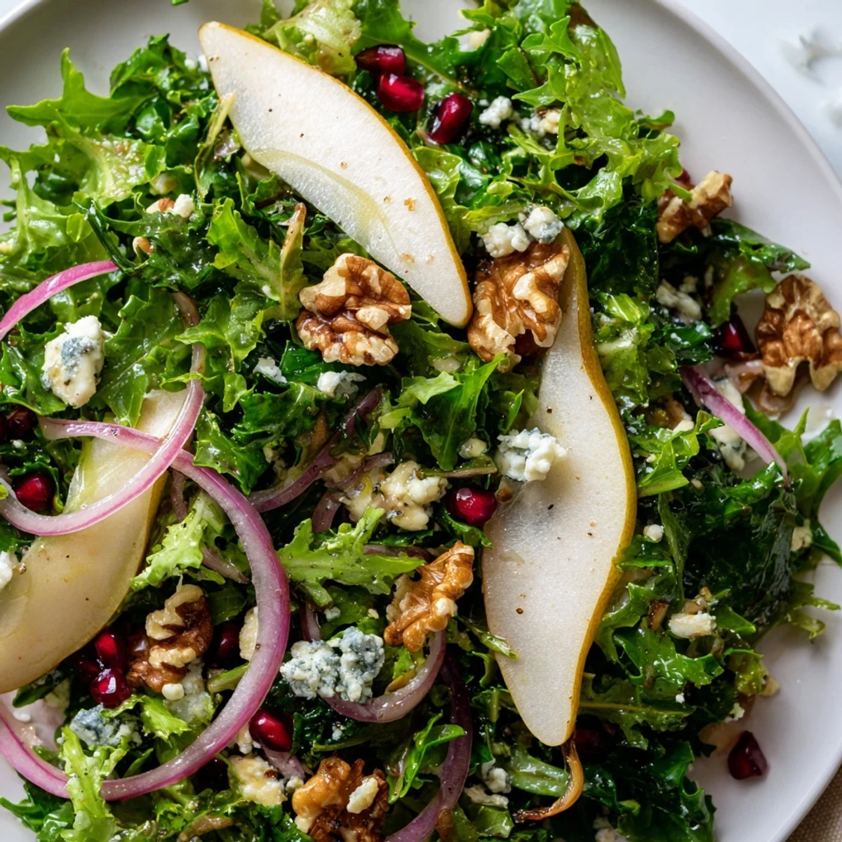 Close-up of a delightful Winter Green Salad showcasing pears, walnuts, and greens, ready to enjoy.
