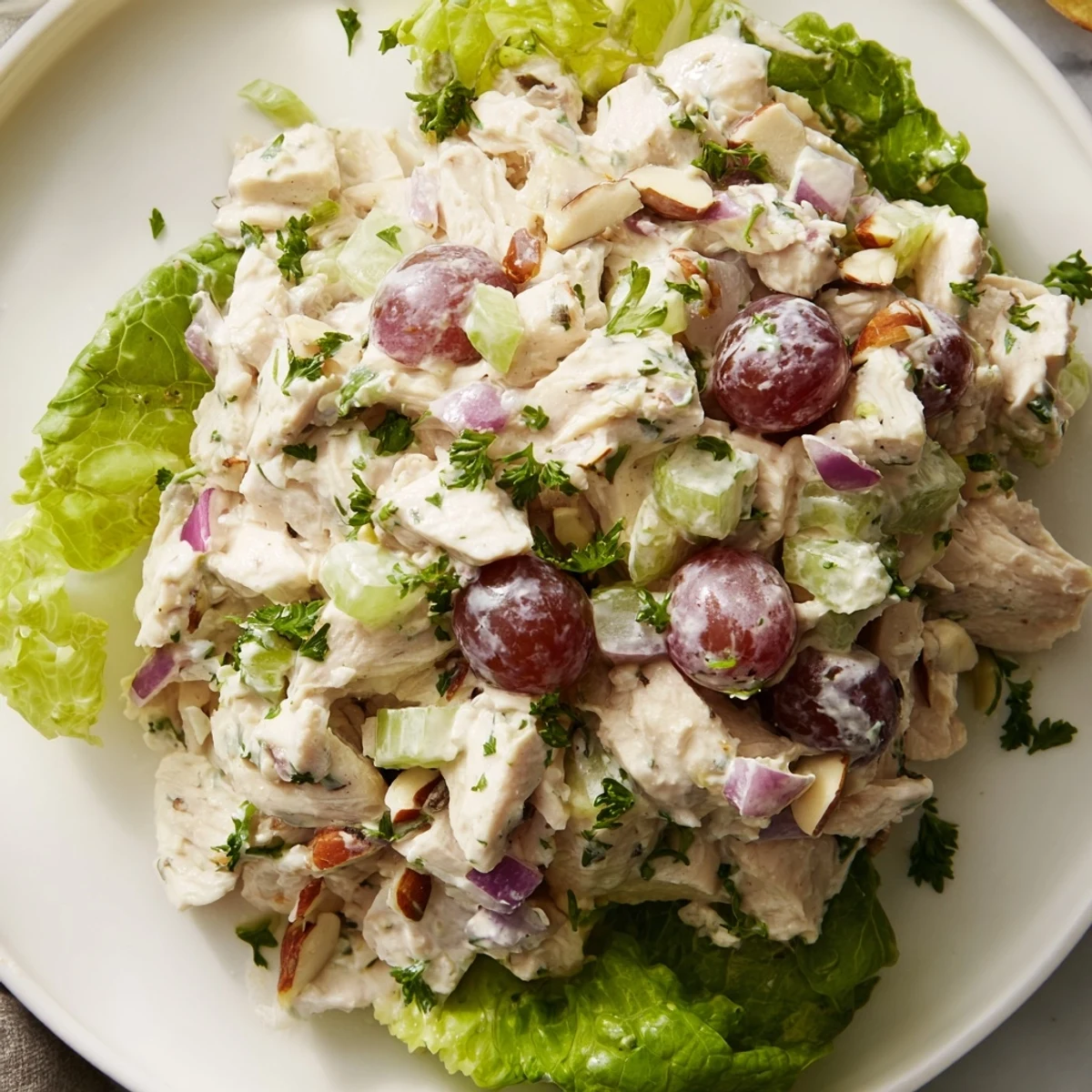 Scoops of creamy Chicken Salad Scoop on a bed of crisp lettuce, ready for a light lunch.