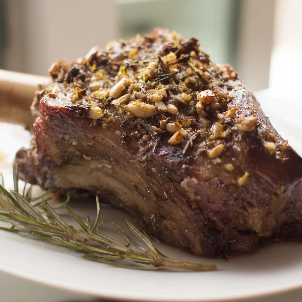 A rustic platter of Roasted Lamb Shoulder with Vegetables topped with fresh herbs and lemon zest.