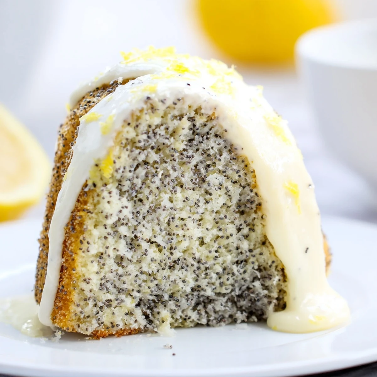 A glazed Lemon Poppy Seed Bundt Cake sits on a cooling rack, ready to be sliced and served.