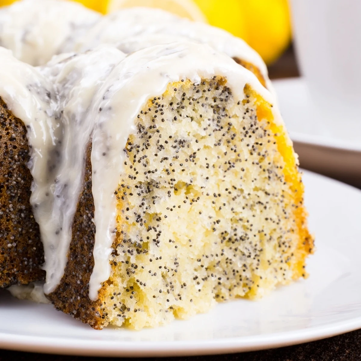 Golden brown Lemon Poppy Seed Bundt Cake with a thick lemon cream glaze, perfect for a springtime dessert.