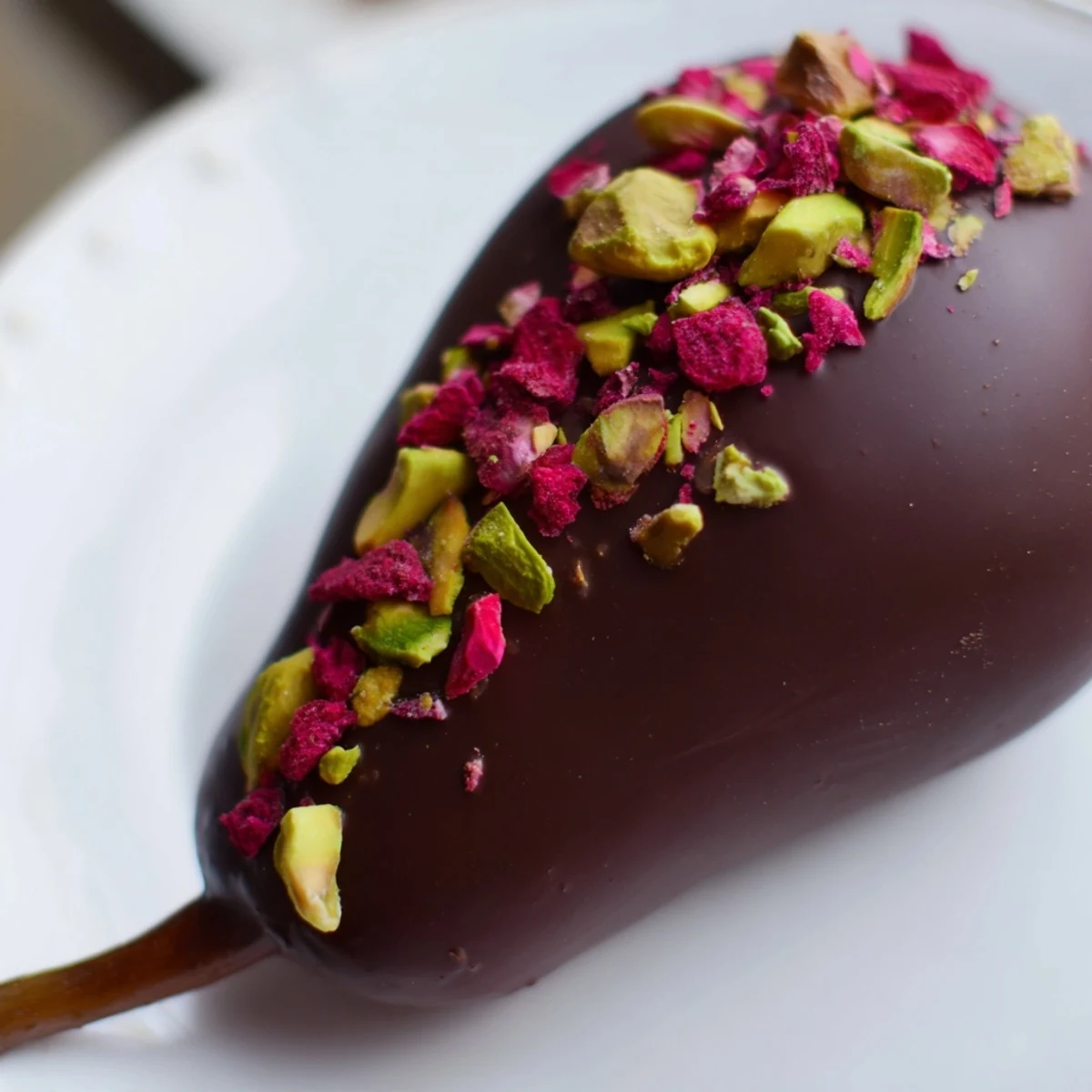 Four Romantic Chocolate Covered Pears on a platter, stems intact and silky dark chocolate glistening.
