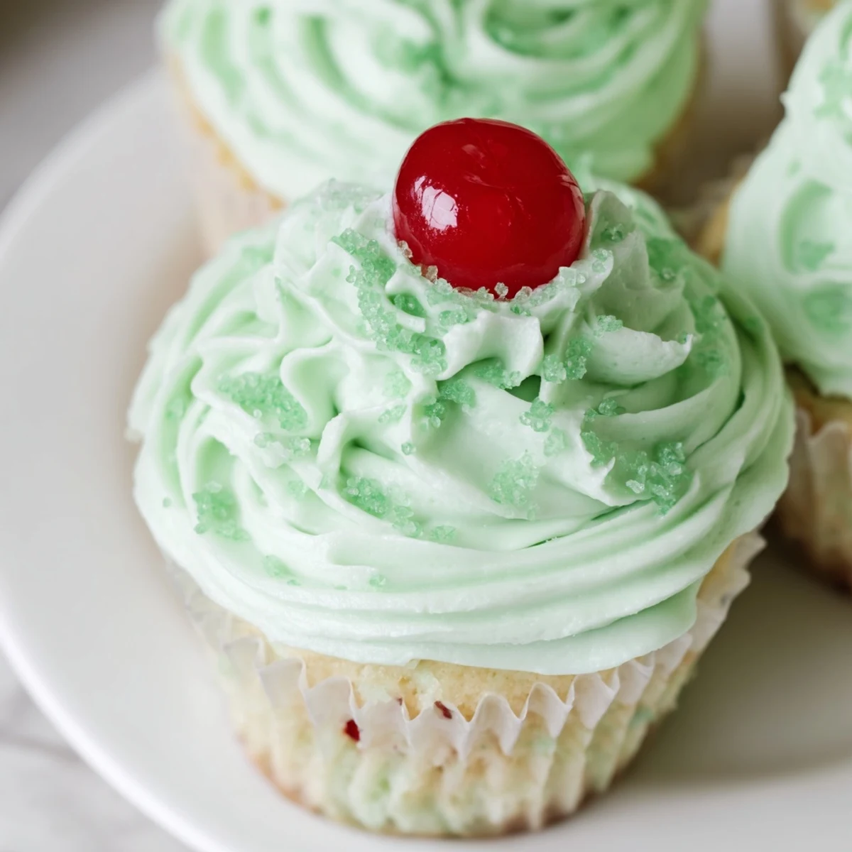 U.S. St. Patrick's Day dessert of Shamrock Shake Cupcakes with mint frosting and a maraschino cherry on top.