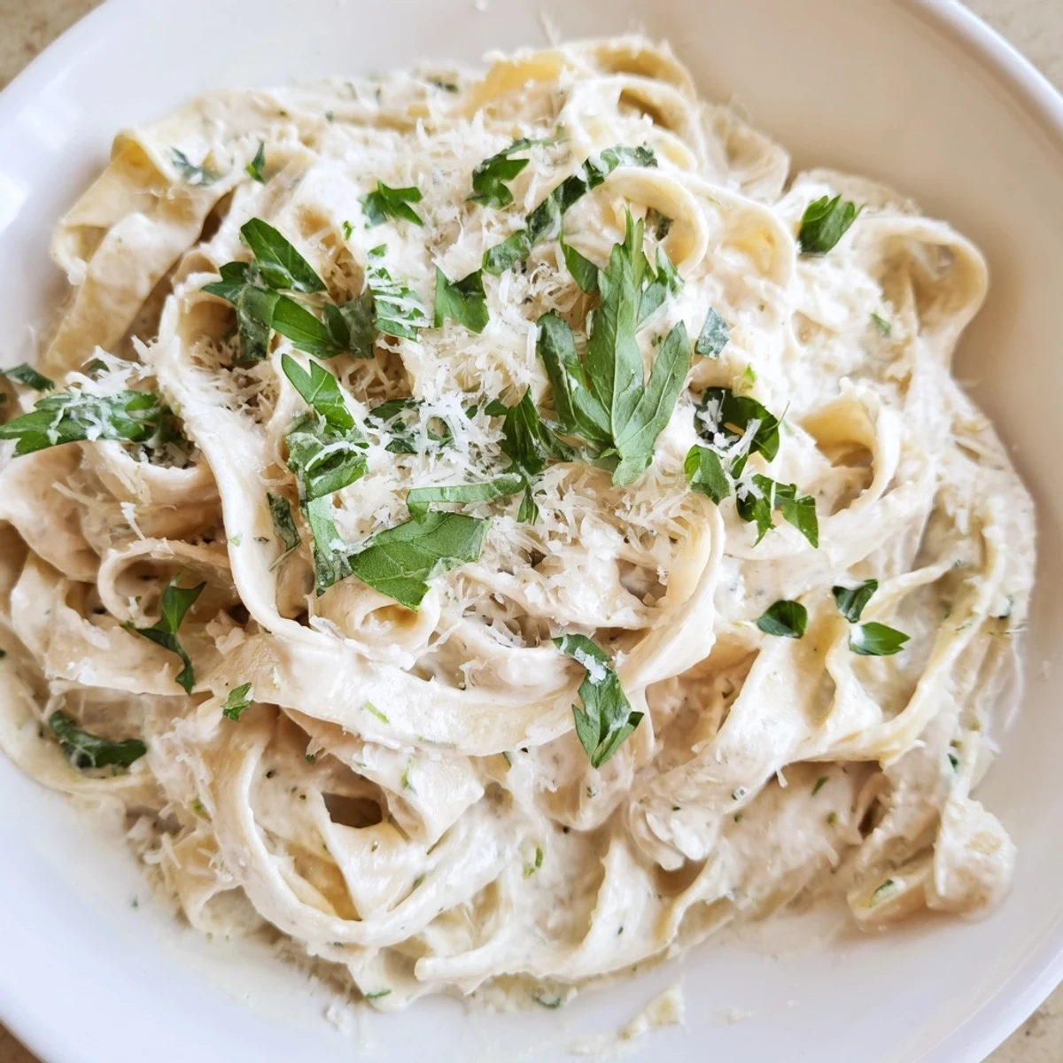 Creamy Garlic Pasta with Herbs plated beside a glass of white wine, perfect for a comforting weeknight meal.