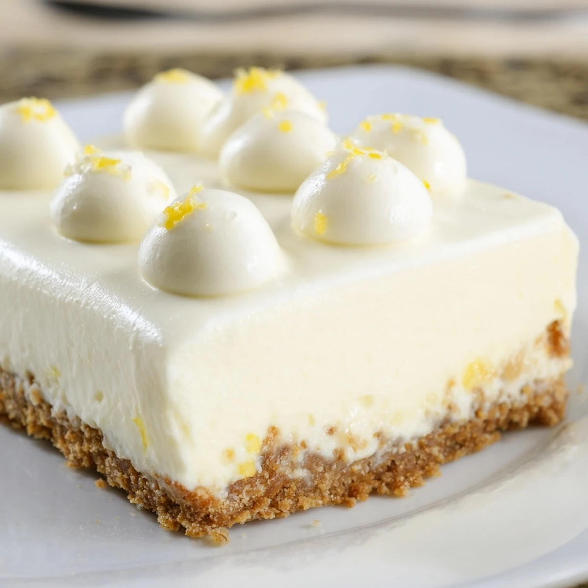 A whole rich Greek Yogurt Cheesecake in a springform pan showcases a smooth, creamy surface and golden graham cracker crust. 
