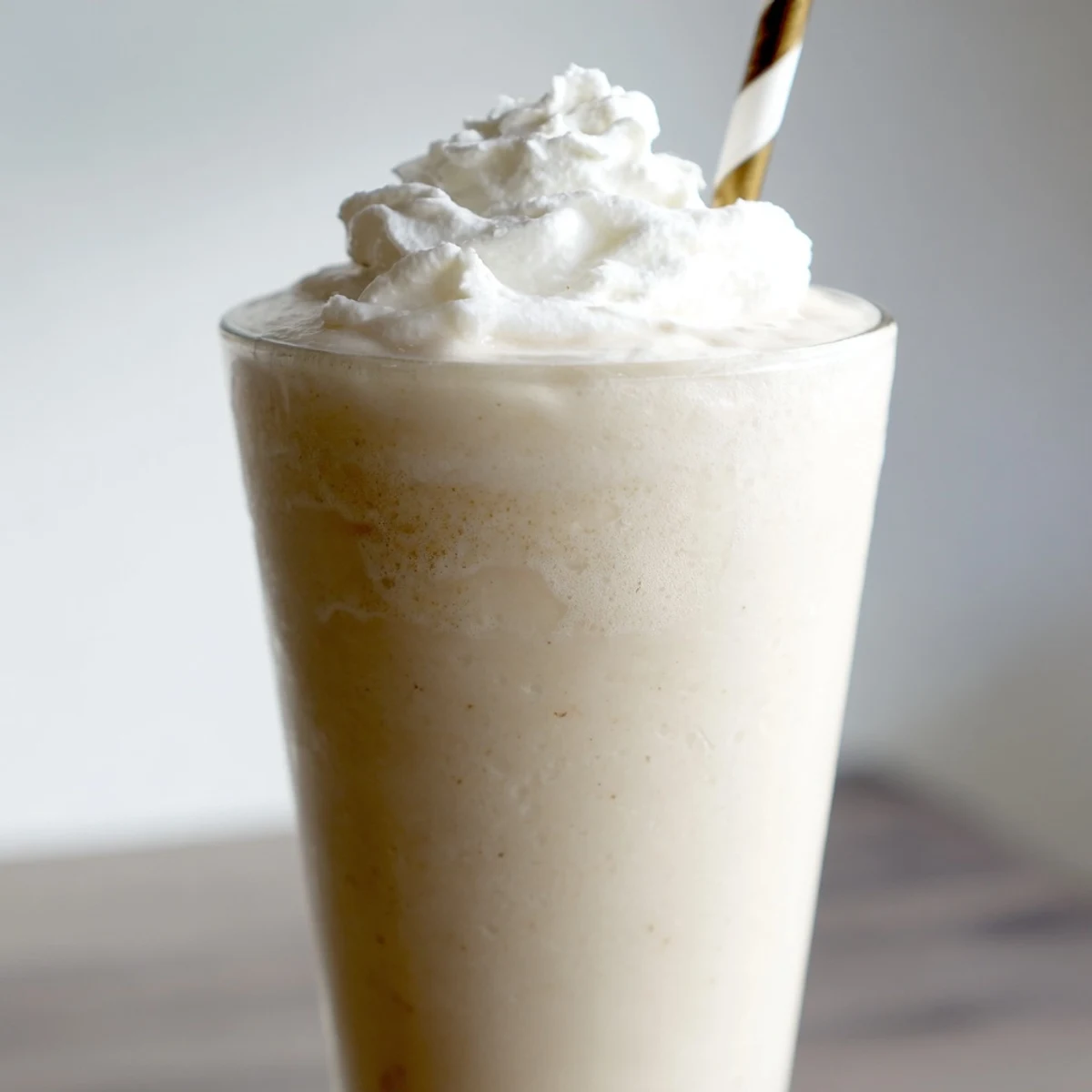 A blended Starbucks Vanilla Bean Frappuccino beverage with vanilla bean ice cream and whipped cream.