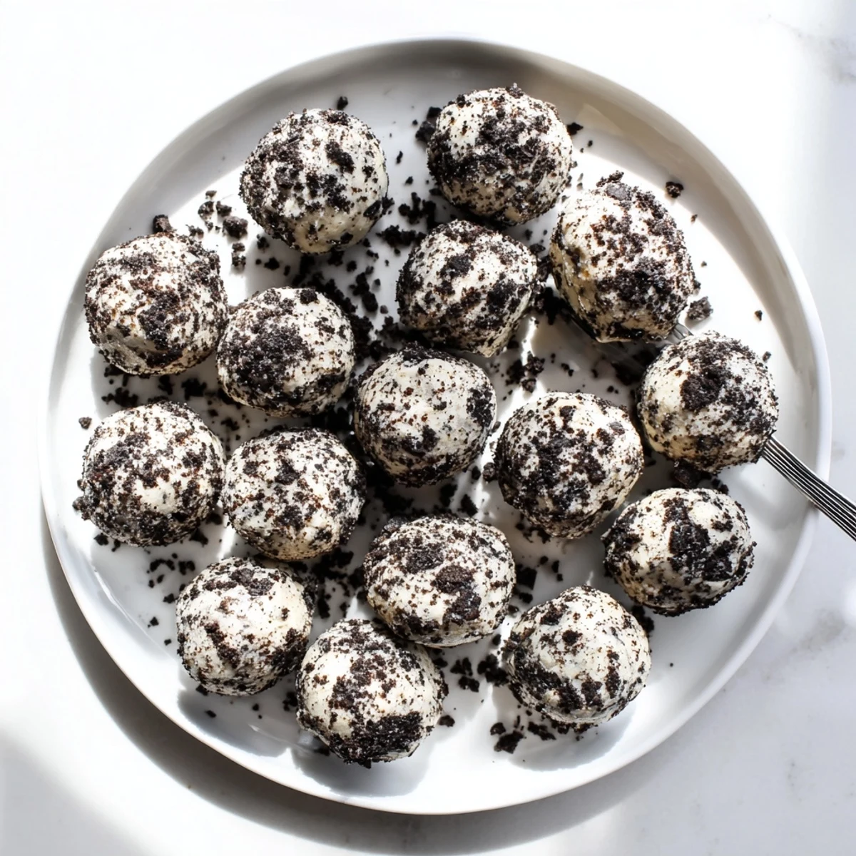 Creamy Oreo protein balls rolled in cookie crumbs, ready to serve as an easy no-bake dessert or post-workout snack.