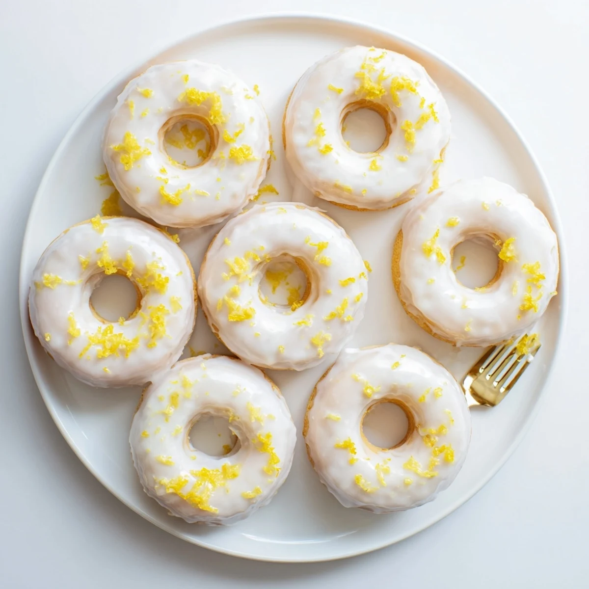 Soft chewy lemon mochi donuts drizzled with citrus icing and fresh lemon zest