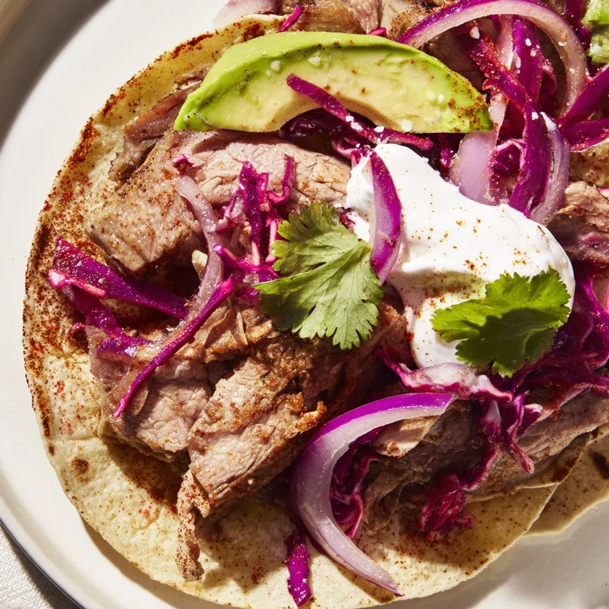 Tender slices of spiced leg of lamb nestled in corn tortillas with vibrant toppings