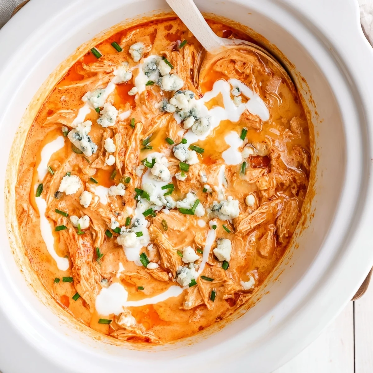 Steaming Buffalo Chicken Dip served with crispy tortilla chips and fresh celery sticks
