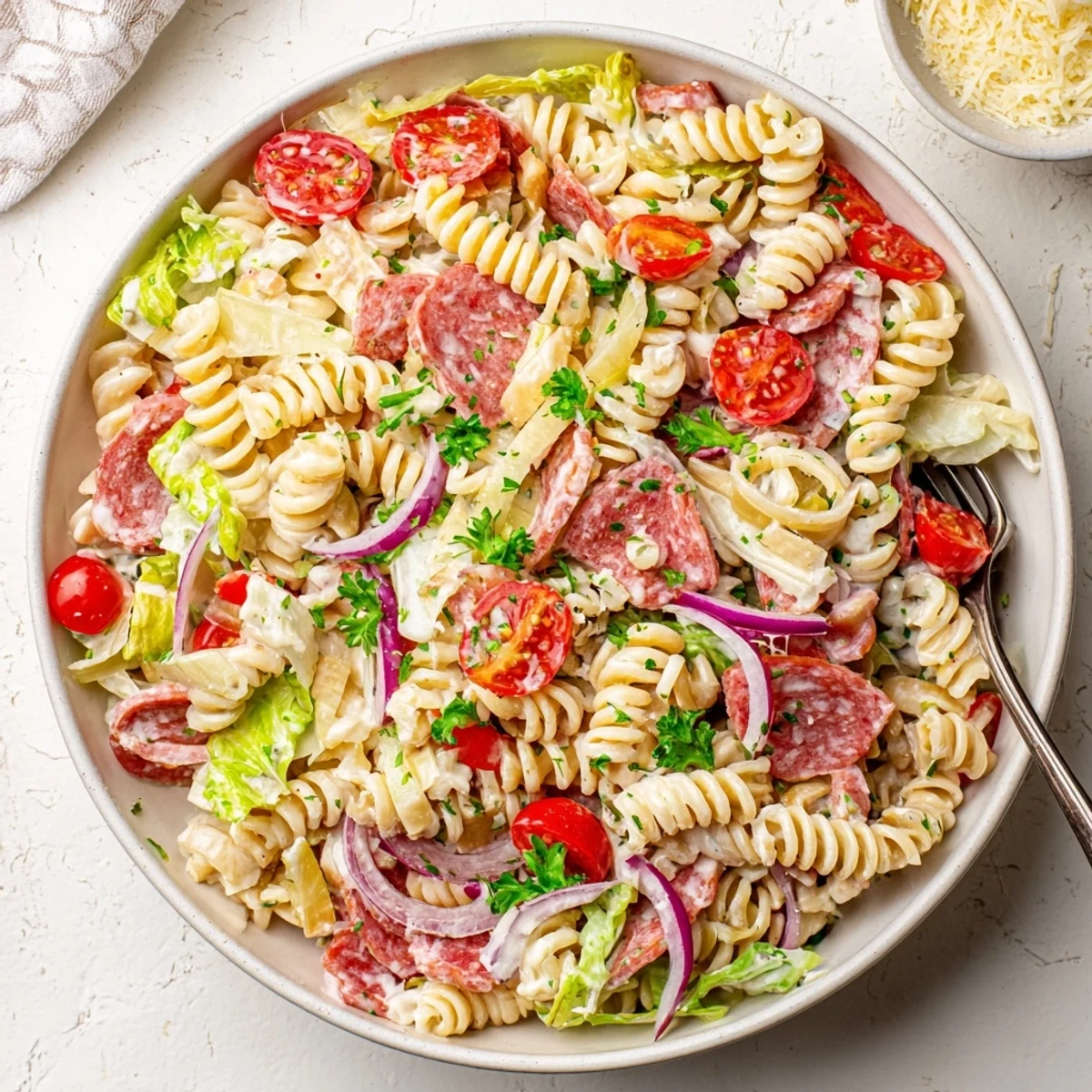 Colorful Italian Grinder Pasta Salad loaded with salami, ham, pepperoni, cheese, and crisp vegetables in a creamy zesty dressing