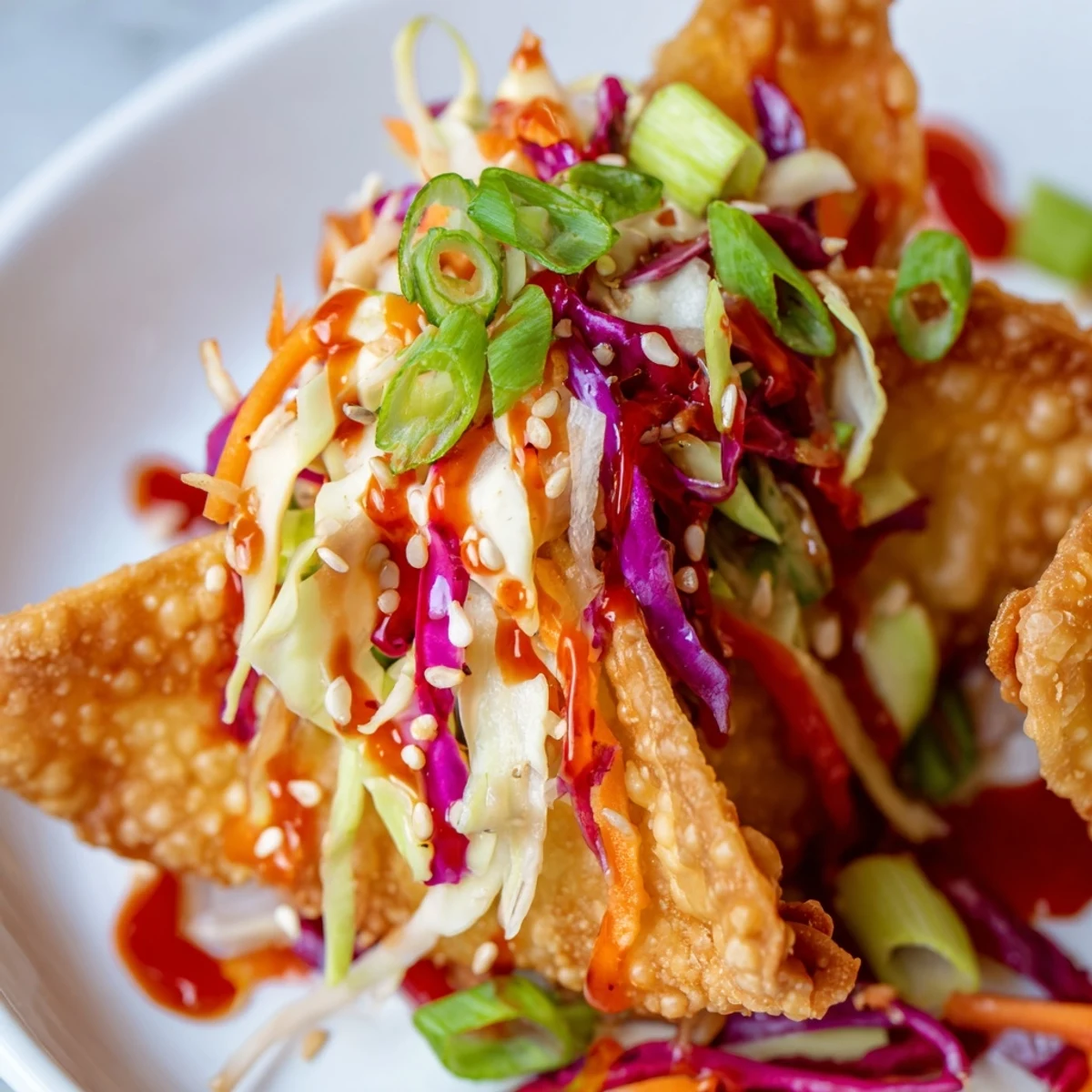 Baked wonton tacos stuffed with seasoned chicken, fresh vegetables, and glossy sweet chili glaze