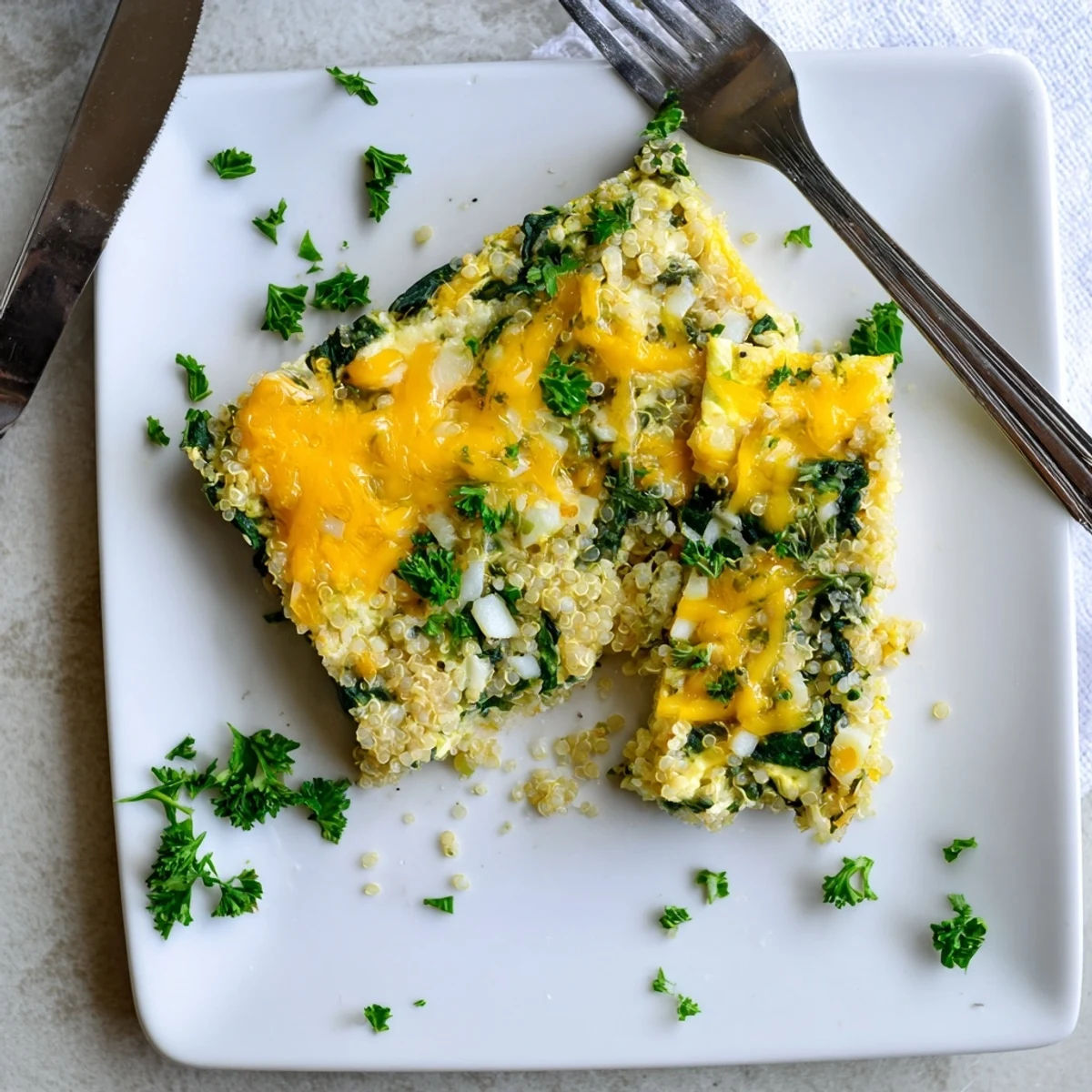Golden cheesy quinoa spinach and egg bake with a bubbly browned top