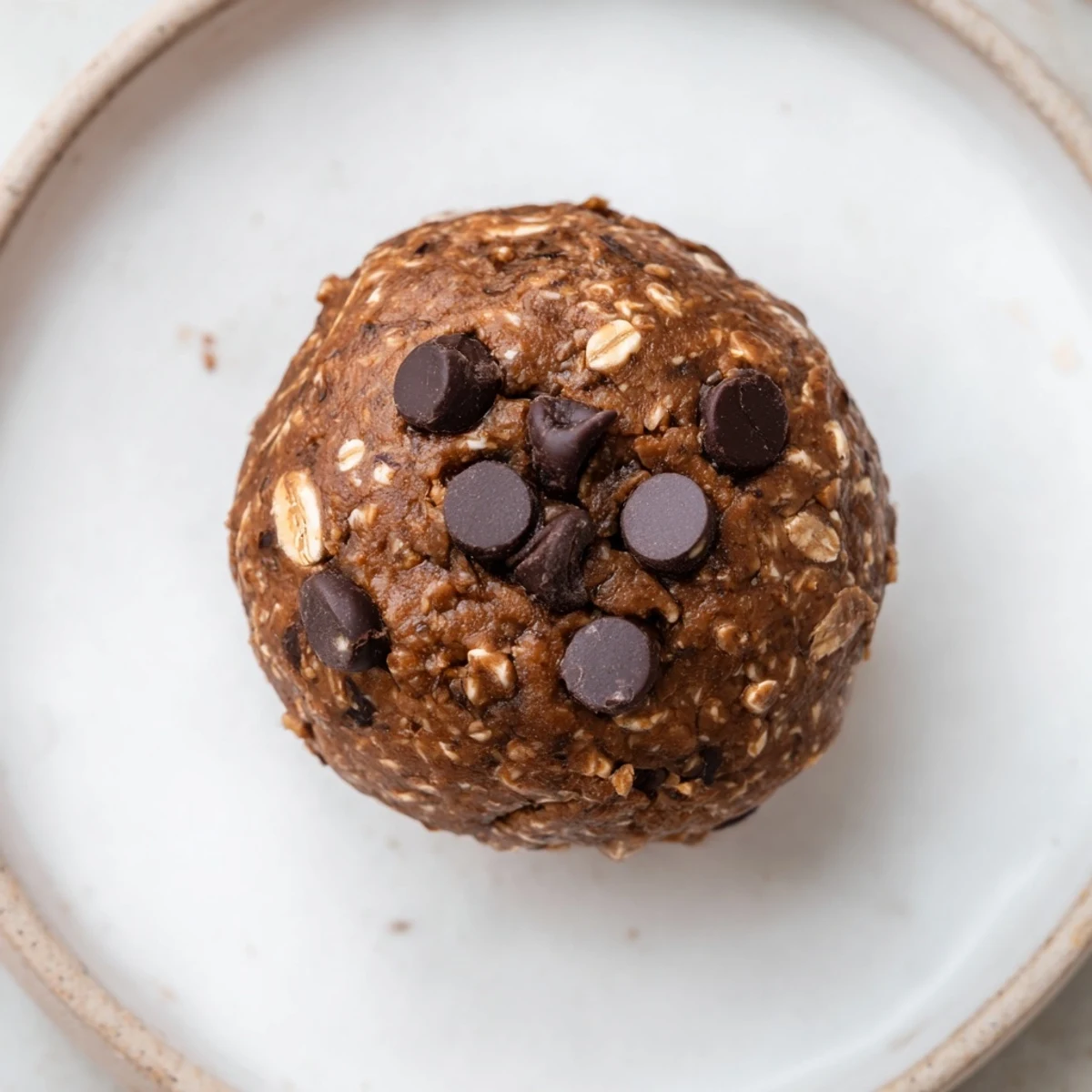 Snack-ready Brownie Protein Bites studded with dark chocolate, nutty peanut butter aroma