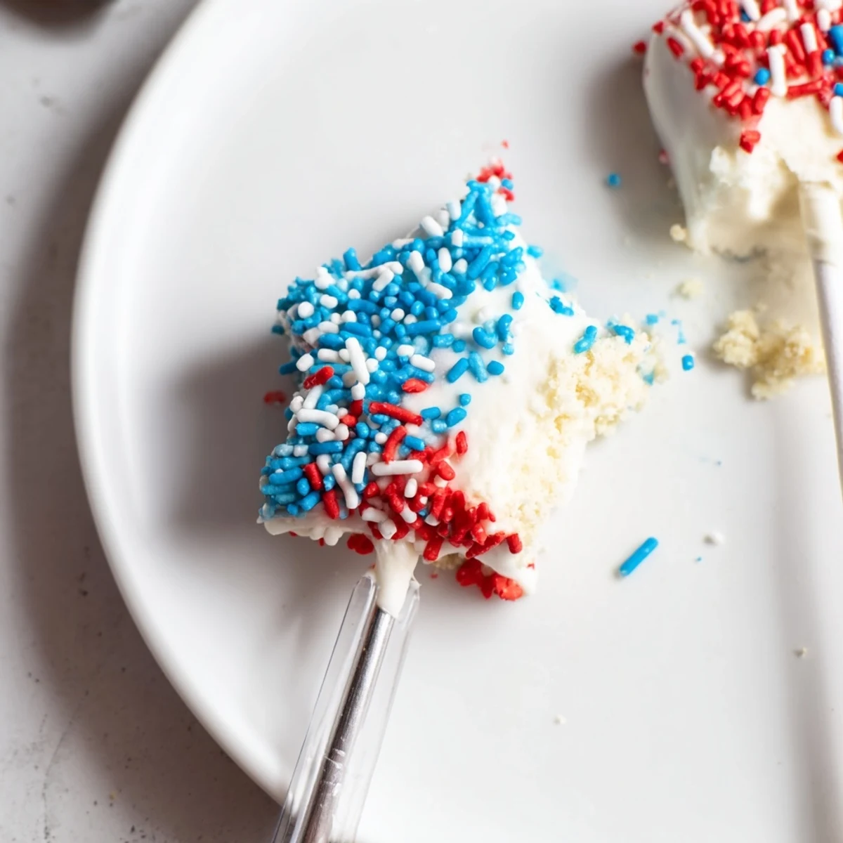 Fourth Of July Star Cheesecake Pops with glossy chocolate coating and crunchy sprinkles