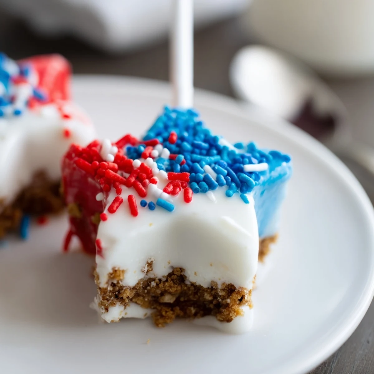 Fourth Of July Star Cheesecake Pops dipped in red, white, and blue chocolate