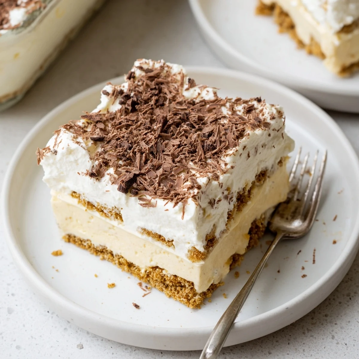 Chilled No Bake Layered Dessert topped with chocolate shavings, light whipped cream