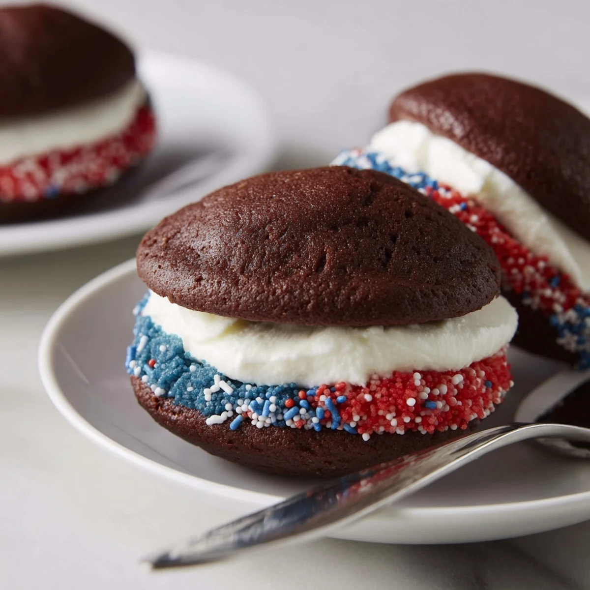 Patriotic Whoopie Pies with red, white, blue frosting, soft cake centers