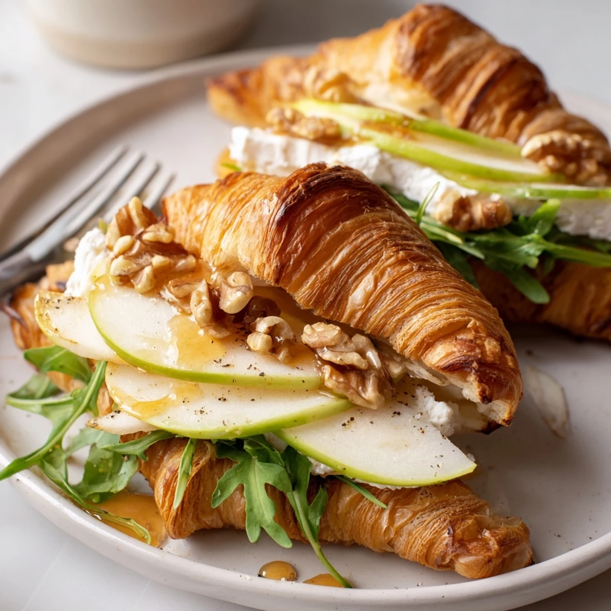 Toasted Apple Goat Cheese Croissant Sandwich with arugula, walnuts for crunchy brunch bite