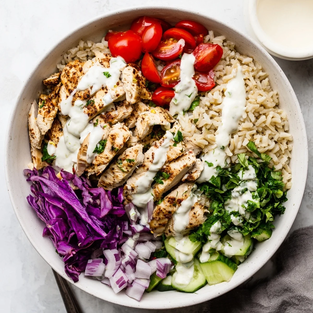 Vibrant Middle Eastern chicken shawarma bowl packed with marinated chicken fresh cucumber tomatoes and red cabbage on brown rice