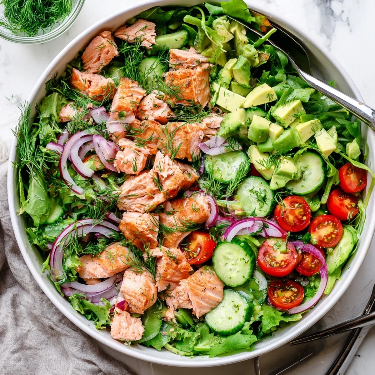 Protein-packed Ultimate Salmon Salad featuring tender flaked salmon, sliced red onion, juicy tomatoes, and creamy avocado tossed in zesty lemon-dill dressing