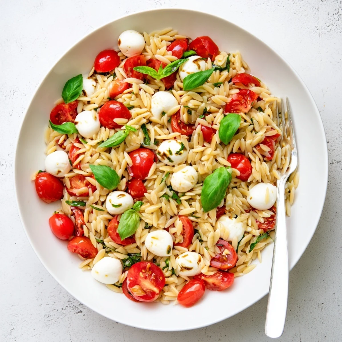 Refreshing Caprese Orzo Pasta Salad tossed with fragrant basil leaves and drizzled with balsamic vinaigrette dressing