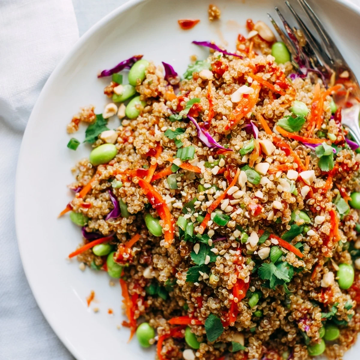A bowl of Asian Dressing Quinoa Salad bursting with colorful vegetables and sesame