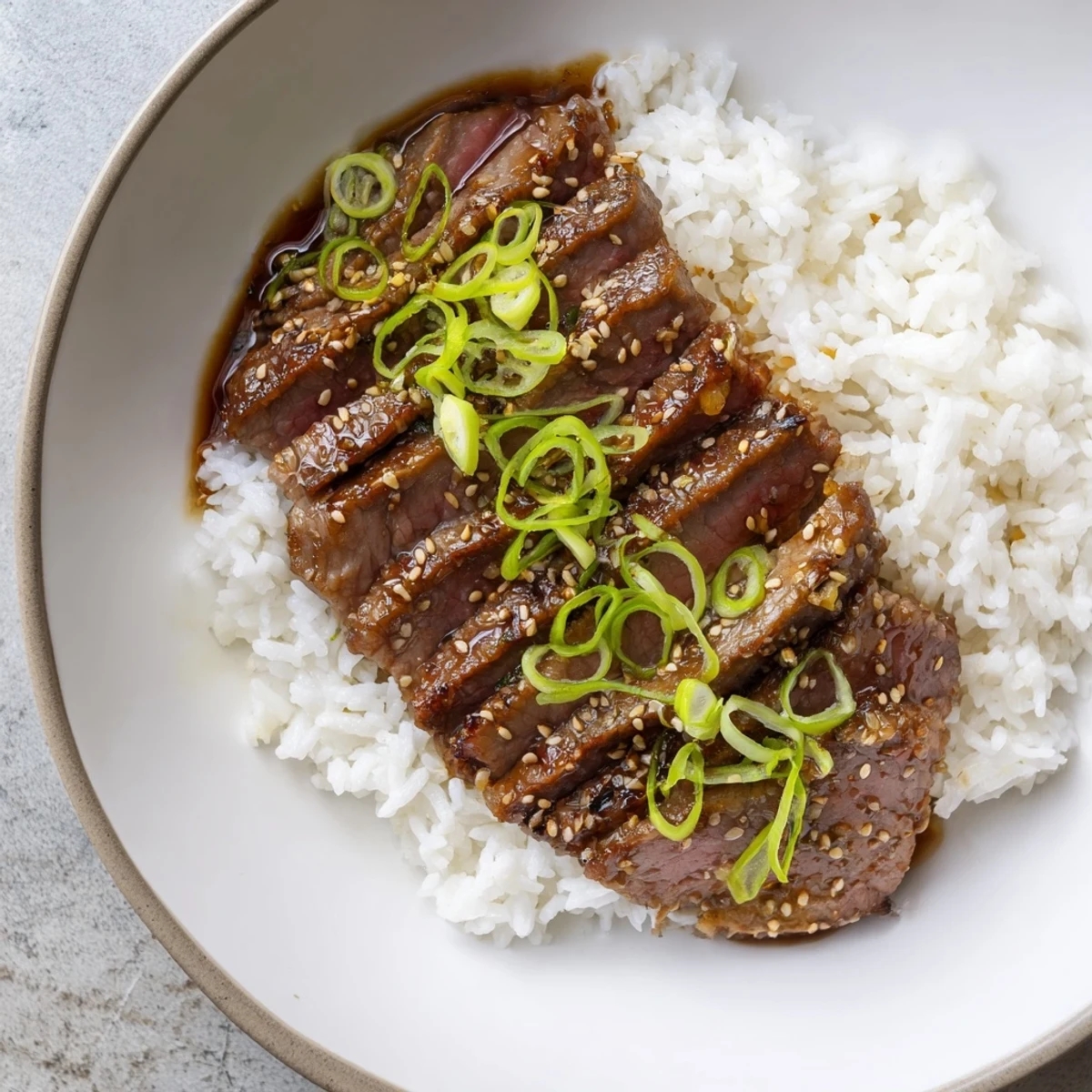 Sizzling Korean Beef tossed in glossy savory sweet sauce over steamed rice