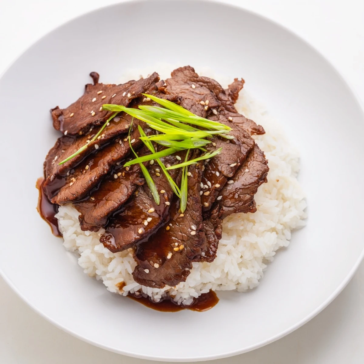 Weeknight Korean Beef plated over rice, fragrant garlic and ginger sauce, ready