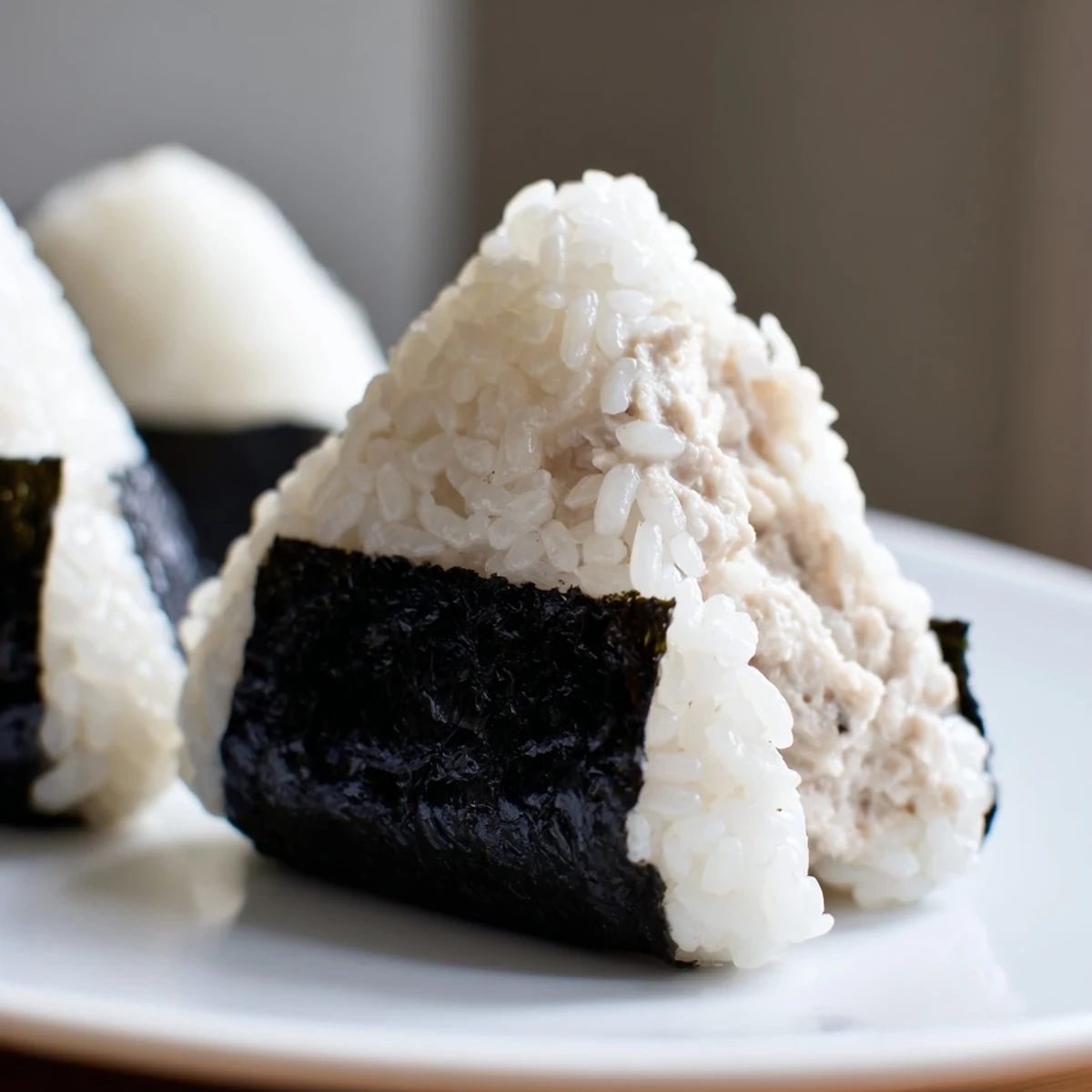 Creamy tuna mayonnaise filling stuffed inside warm Japanese rice ball lunch snack