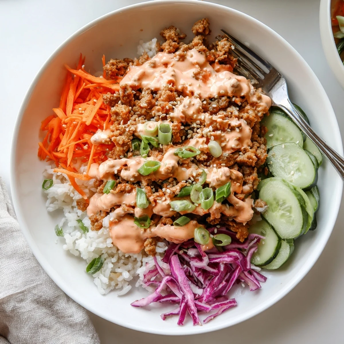 Colorful Ground Turkey Rice Bowls With Bang Bang Sauce served in white ceramic bowls