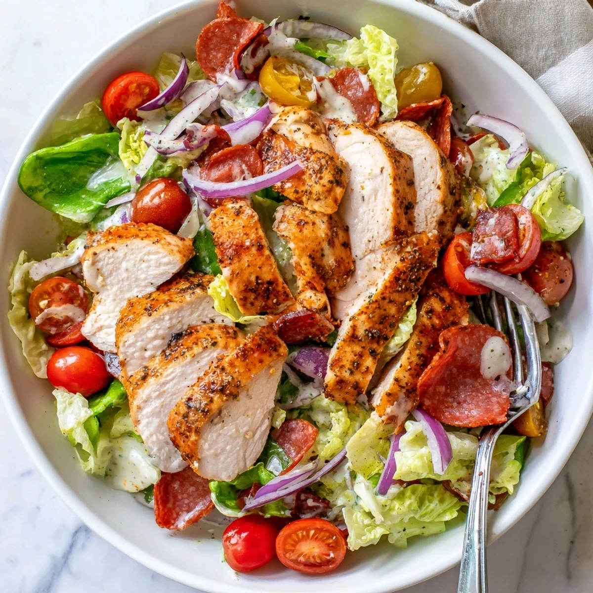 Juicy grilled chicken topped with salami, provolone, and crisp romaine in a zesty Italian Grinder Chicken Salad
